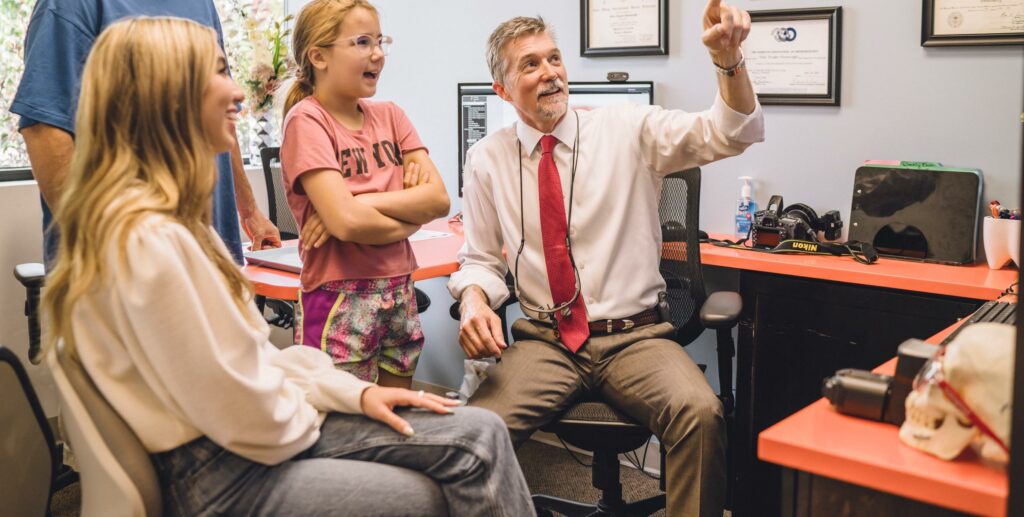 Doctor Wade in Inspire Orthodontics office with patient family