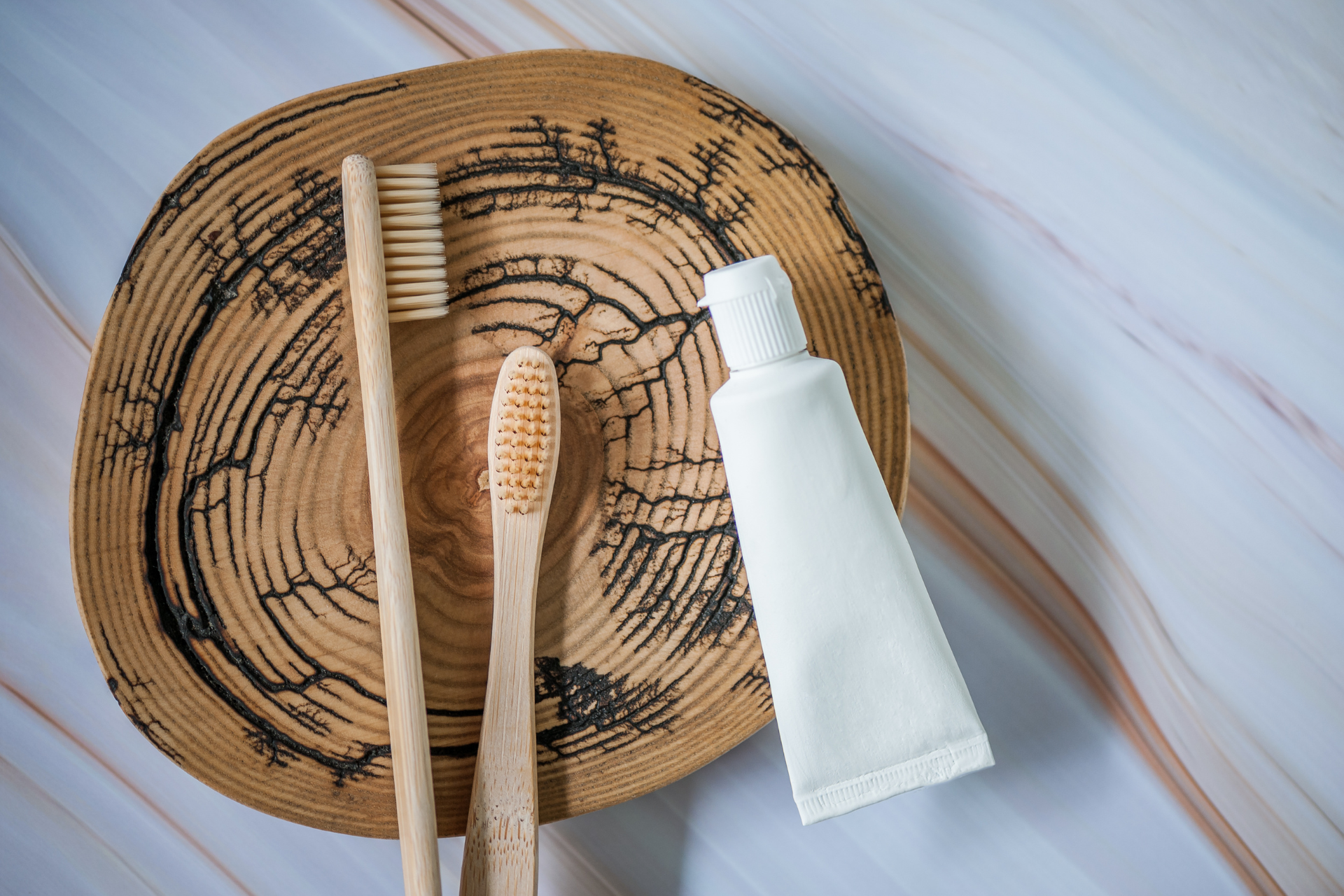 toothbrushes sitting in bathroom on decorative log