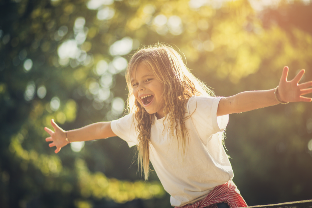 happy girl running with outstretched arms