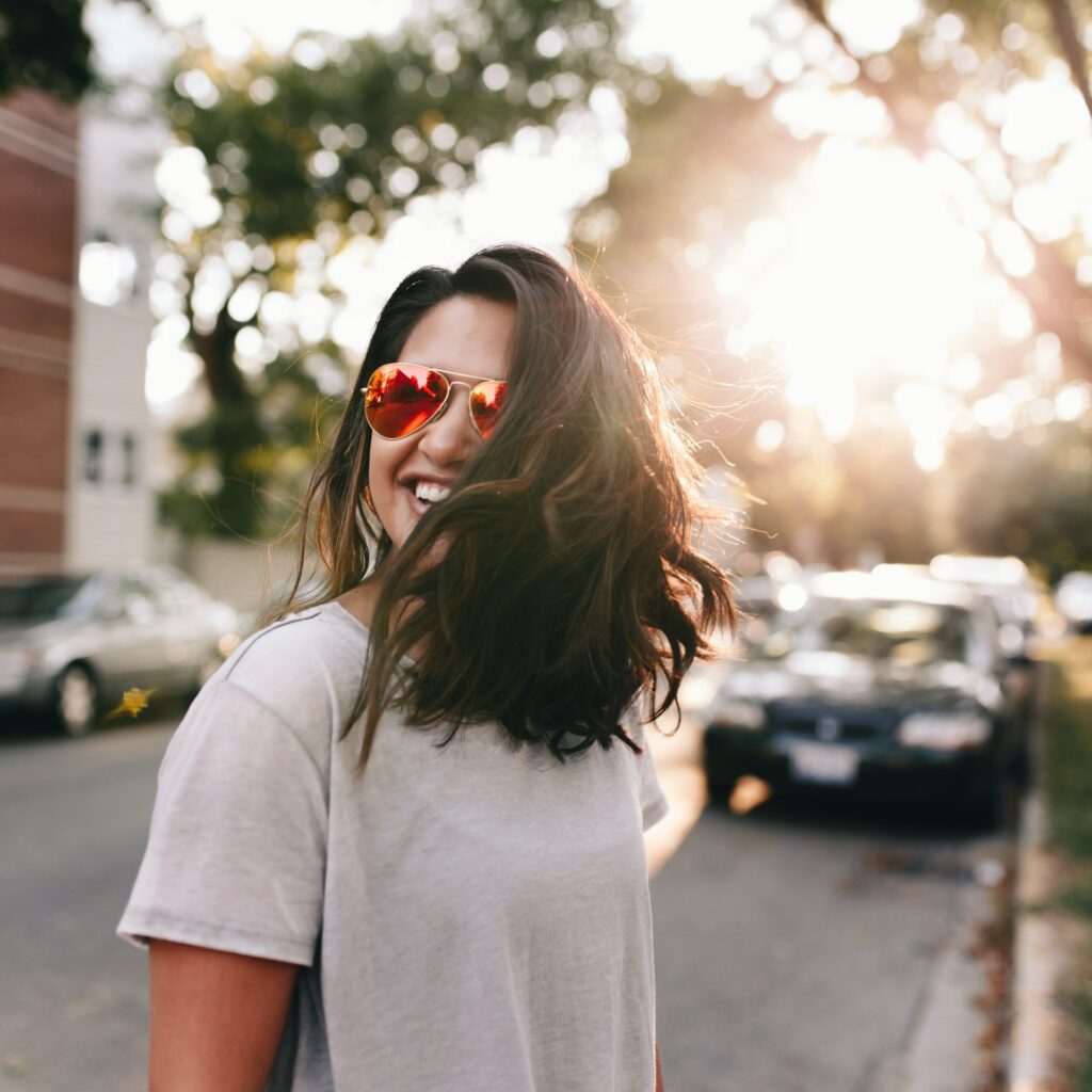 girl spinning while smiling in the street